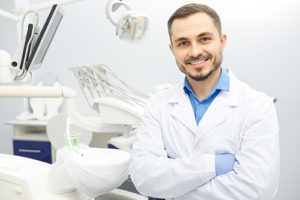 smiling male dentist with crossed arms, about lovett dental pasadena