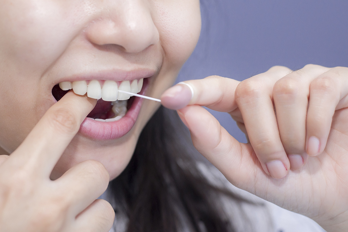 benefits of flossing daily (4) woman showing the benefits of flossing daily