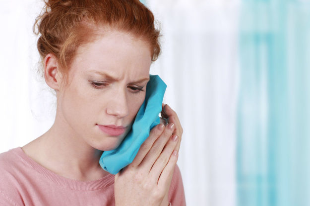 what is a dental emergency (1) woman with ice pack on cheek wondering What is a Dental Emergency?