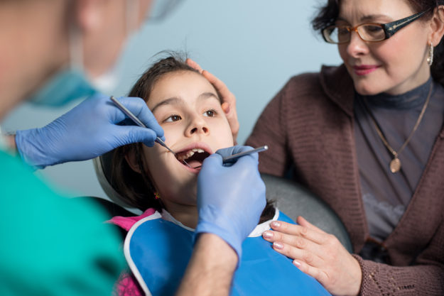 pediatric dental emergency dentist working on child having a pediatric dental emergency