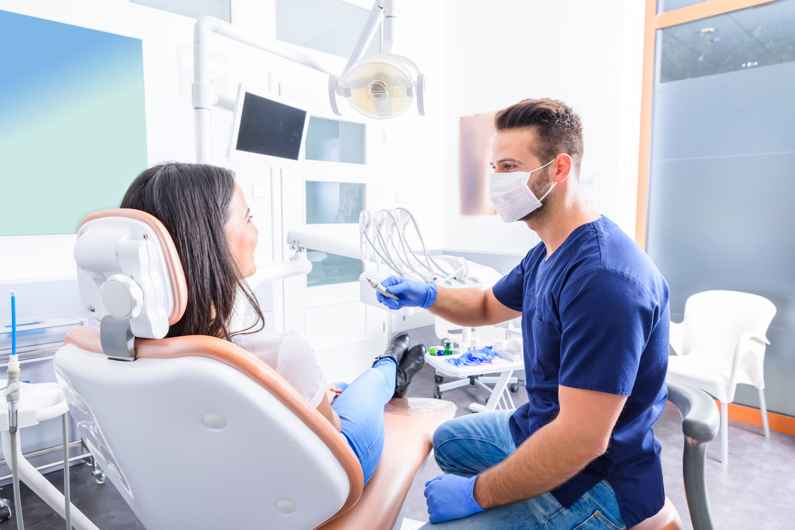 a woman talking to her dentist about types of dental implants