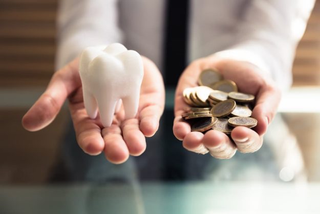 a person wondering about the cost of veneers