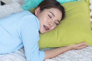 woman experiencing teeth grinding in sleep