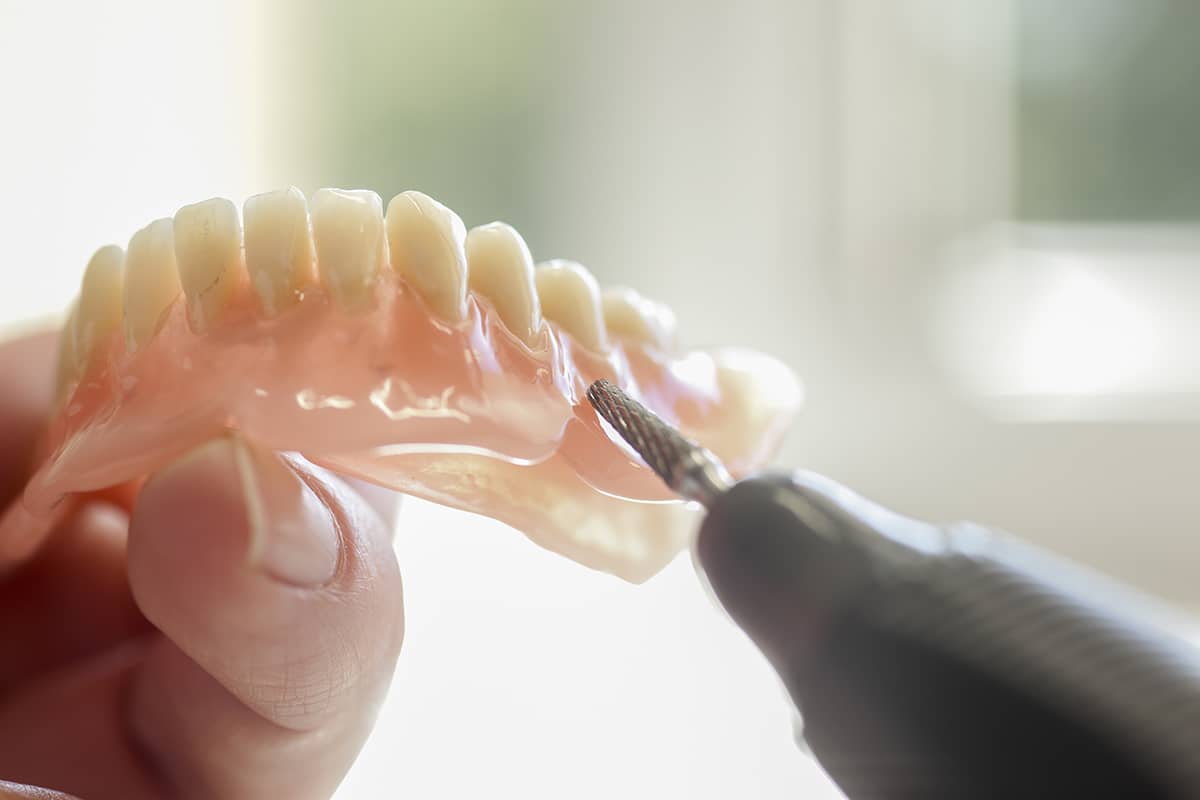 types of dentures dentist working on types of dentures