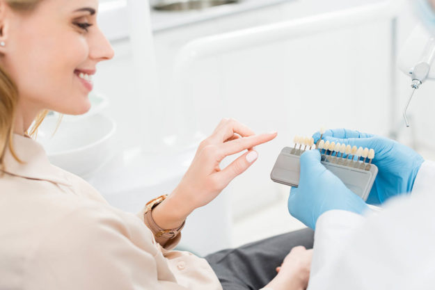 4 Benefits of Dental Implants woman picks out dental implants